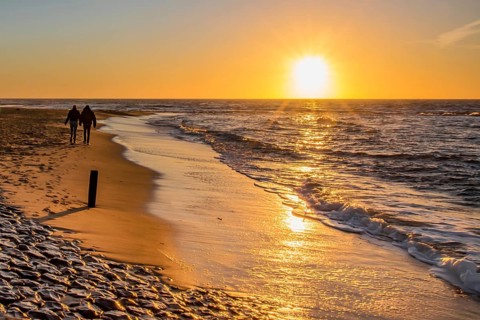 Den Helder, Netherlands. January 2022. Setting sun on the beach of Den Helder, Netherlands.