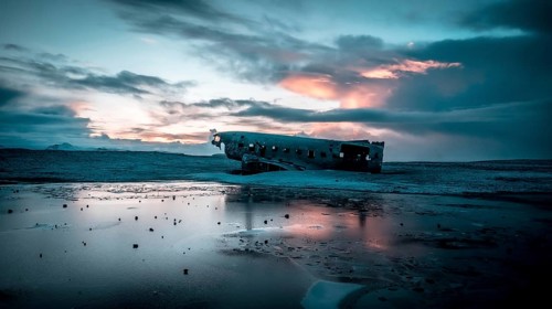 Aerial drone view of crashed plane on frozen Solheimasandur beach in winter, Iceland, Europe