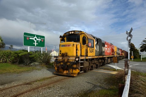 HOKITIKA, NEW ZEALAND, AUGUST 29, 2020: A freight train crosses the main street of Hokitika near