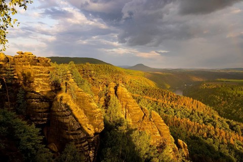 Schrammstein view in the Elbe Sandstone Mountains Looking up the Elbe. Leisurely hikers clamber