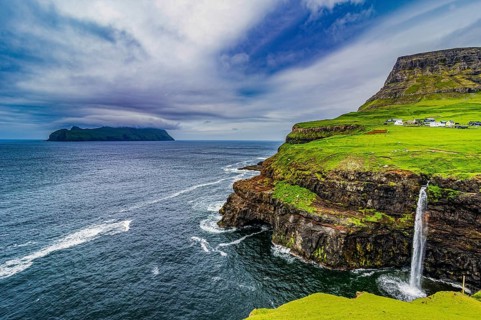 Gasadalur waterfall into the ocean, Vagar, Faroe islands, Denmark, Europe