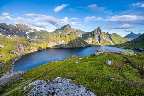 Mountain landscape with lake Tennesvatnet, at sunrise, in the back peak of Hermannsdalstinden,