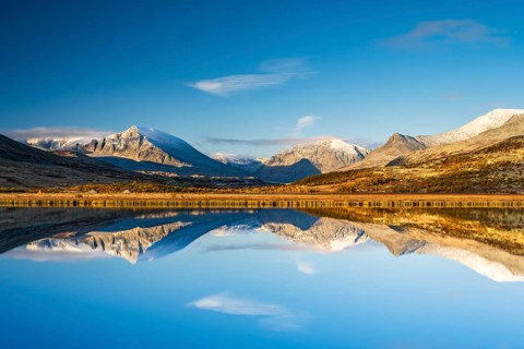 Reflection of the autumn landscape in Rondane National Park, mountains, Doraldalen, Norway, Europe