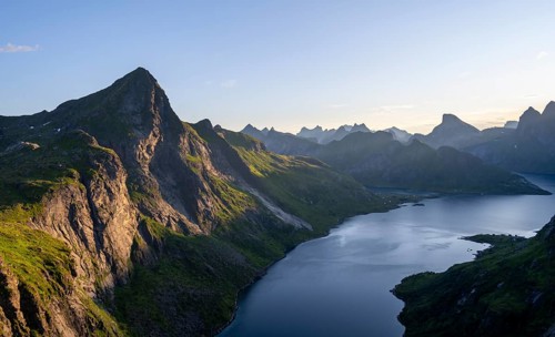 Mountain landscape with pointed mountain peaks and fjord Forsfjorden with village Vindstad, at