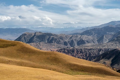 View over eroded mountainous landscape with brown hills, mountains and steppe, Chuy province,