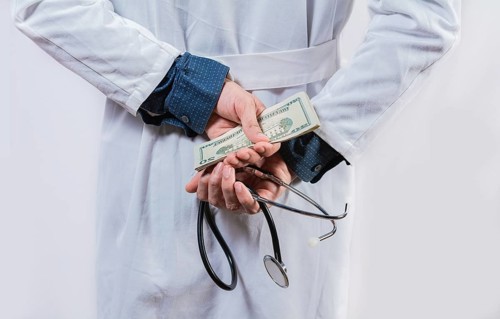 Dishonest doctor hiding money. Medical corruption and bribery concept, Corrupt doctor hiding money