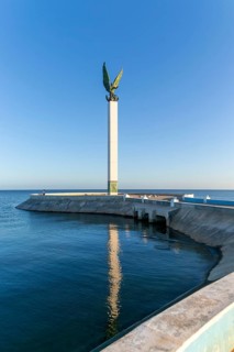 Sculpture of winged Mayan Angel on tall column, the seafront Malecon, Campeche city, Campeche