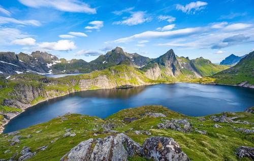 Mountain landscape with lake Tennesvatnet, at sunrise, in the back peak of Hermannsdalstinden,