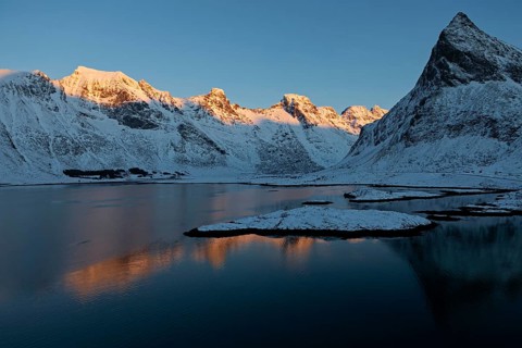 Illuminated mountain range on the Lofoten Islands near Ramberg, Norway, Europe