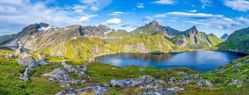Mountain landscape with steep rocky peaks and lake Tennesvatnet, in the back peak of