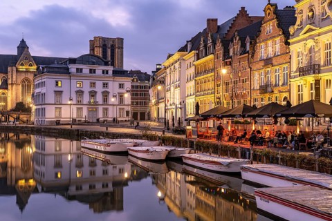 Gastronomy and historic houses on the Korenlei quay on the river Leie at dusk, Ghent, Belgium,