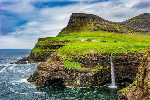 Gasadalur waterfall into the ocean, Vagar, Faroe islands, Denmark, Europe