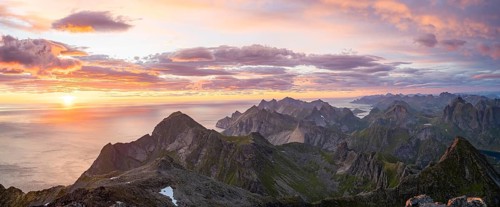 View over mountain top and sea, dramatic sunset, from the top of Hermannsdalstinden, Moskenesöy,