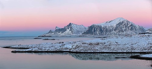 Ramberg with the mountains Hustinden and Bjorntinden in the background in winter dusk