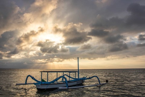 Jukung in the sea, typical landscape shot with a view of the horizon over the water, taken from a