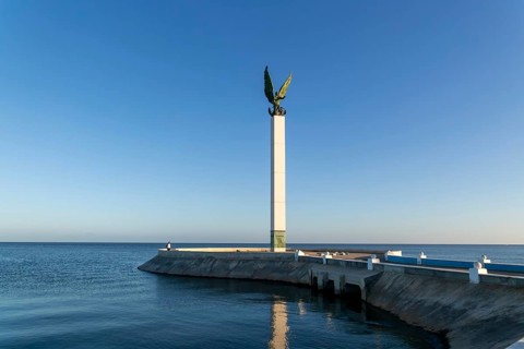Sculpture of winged Mayan Angel on tall column, the seafront Malecon, Campeche city, Campeche