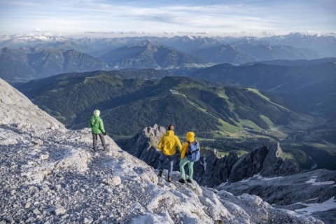 Three hikers look down into the valley from the Hochkönig, Salzburger Land, Austria, Europe