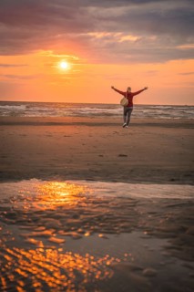 Tourist on the beach at sunset, Zandvoort, Netherlands