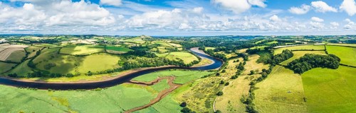 Panorama over Sharpham Meadows and Marsh over River Dart from a drone, Totnes, Devon, England,