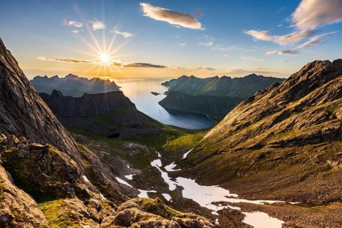 View over Senja's fjords and mountain peaks under the midnight sun, Mount Grytetippen, Senja,