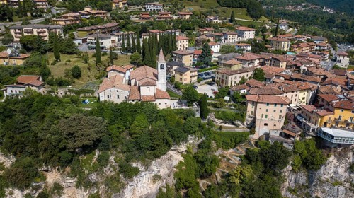 View of village resort Tremosine in the middle Catholic church Chiesa di Pieve on steep rock face