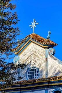 Baroque wooden church tower illuminated by the sun in the city of Diamantina, Minas Gerais, Brasil