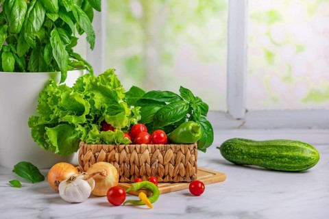 Fresh vegetables in basket, salad ingredients, cucumber, tomatoes, lettuce, basil, pepperoni,