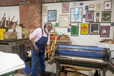 Detroit, Michigan, Amos Kennedy works in his letterpress printing shop. Kennedy prints posters and
