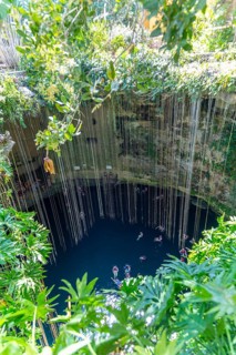 People swimming in limestone sinkhole pool, Cenote Ik kil, Pisté, Yucatan, Mexico, Central America
