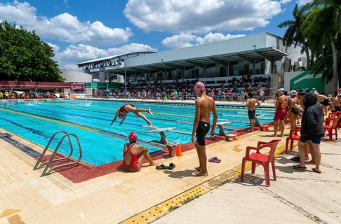Young people at swimming pool gala event, relay race in progress, Campeche city, Campeche State,