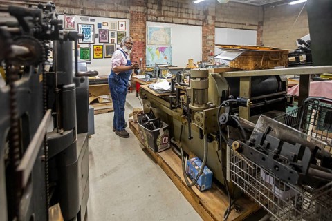 Detroit, Michigan, Amos Kennedy works in his letterpress printing shop. Kennedy prints posters and