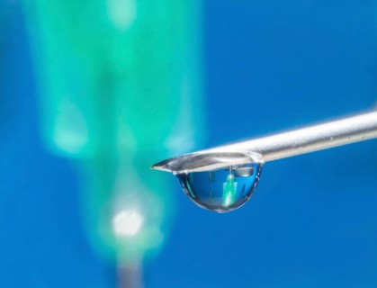 Macro image Covid vaccine, a drop of Moderna vaccine hangs on a vaccine needle