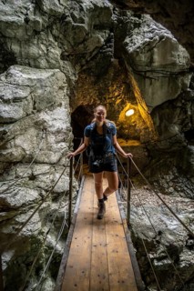 Hiker in a tunnel, Hammersbach flows through Höllentalklamm, near Garmisch-Partenkirchen,