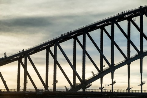 Tourists climbing Sydney harbour bridge at sunset, Sydney, New South Wales, Australia, Oceania
