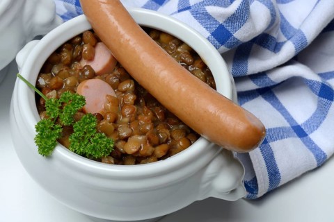 Lentil (Lens culinaris) dish with sausages in bowl, lentil