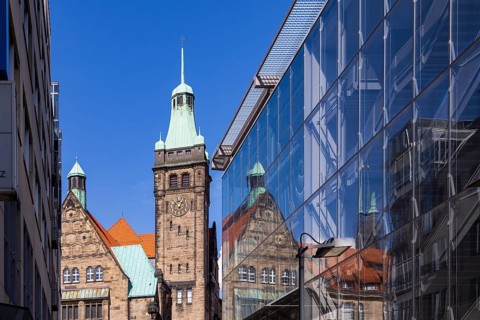 View through Bretgasse to the town hall with the reflection in Galeria Kaufhof