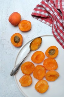 Apricot, apricot halves on plate with spoon