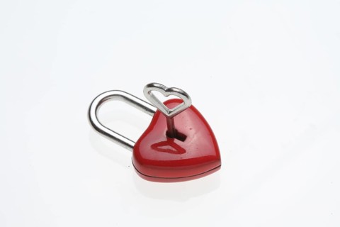 Small red padlock with a heart-shaped key
