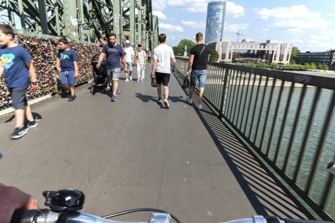 Cycling from a first-person perspective on a shared footpath and cycle path over the Hohenzollern