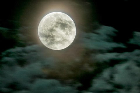 Full moon over Dresden. Fast-moving clouds are illuminated in the night sky by the still low moon