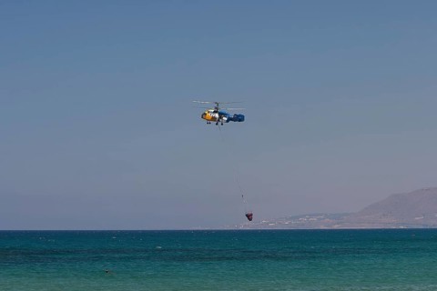 Helicopter, helicopter, fire-fighting helicopter, fire, helicopter close above the water surface,