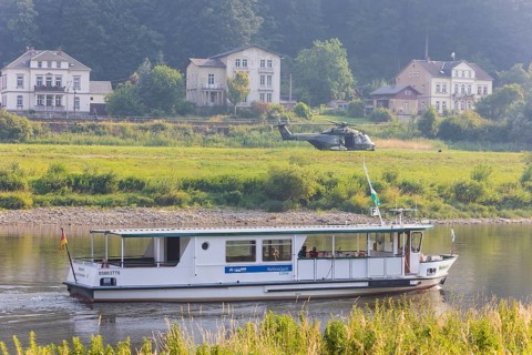 A Bundeswehr helicopter lands on the Elbe meadows in Bad Schandau on the Elbe, after a day of