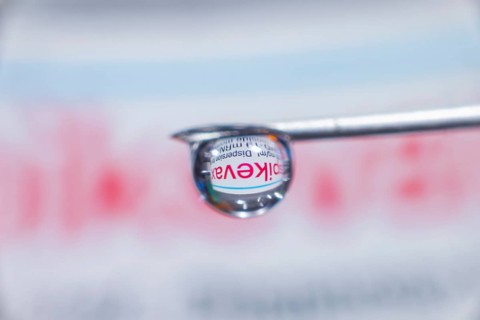 Macro image Covid vaccine, a drop of Moderna vaccine hangs on a vaccine needle
