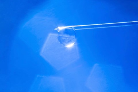 Macro image Covid vaccine, a drop of Moderna vaccine hangs on a vaccine needle