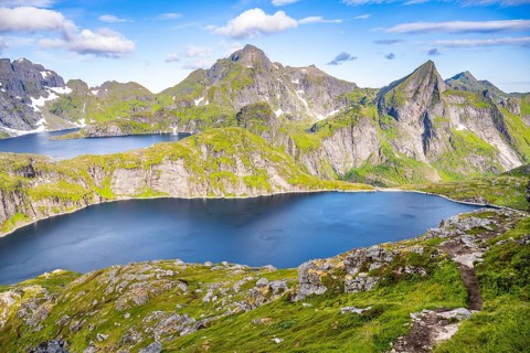 Mountain landscape with steep rocky peaks and lakes Tennesvatnet and Krokvatnet, in the back peak