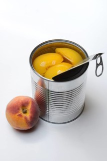 Peach, preserved peach halves with syrup in a tin can