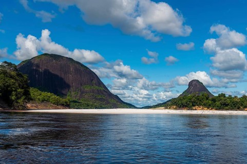 White sand beach before the granite hills of Cerros de Mavecure, Eastern Colombia