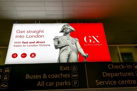 Electronic neon advert for Gatwick Express trains rail service, South Terminal, London Gatwick