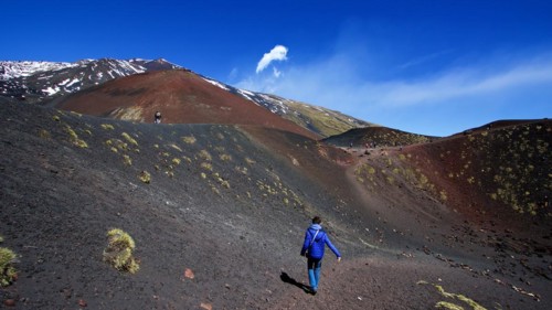 Lone visitor in crater, black lava field, red lava hill, Crateri Silvestri, Etna, volcano, Eastern