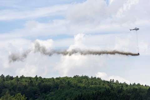 Symbolic image, climate change, helicopter, helicopter spreading finely painted limestone and wood